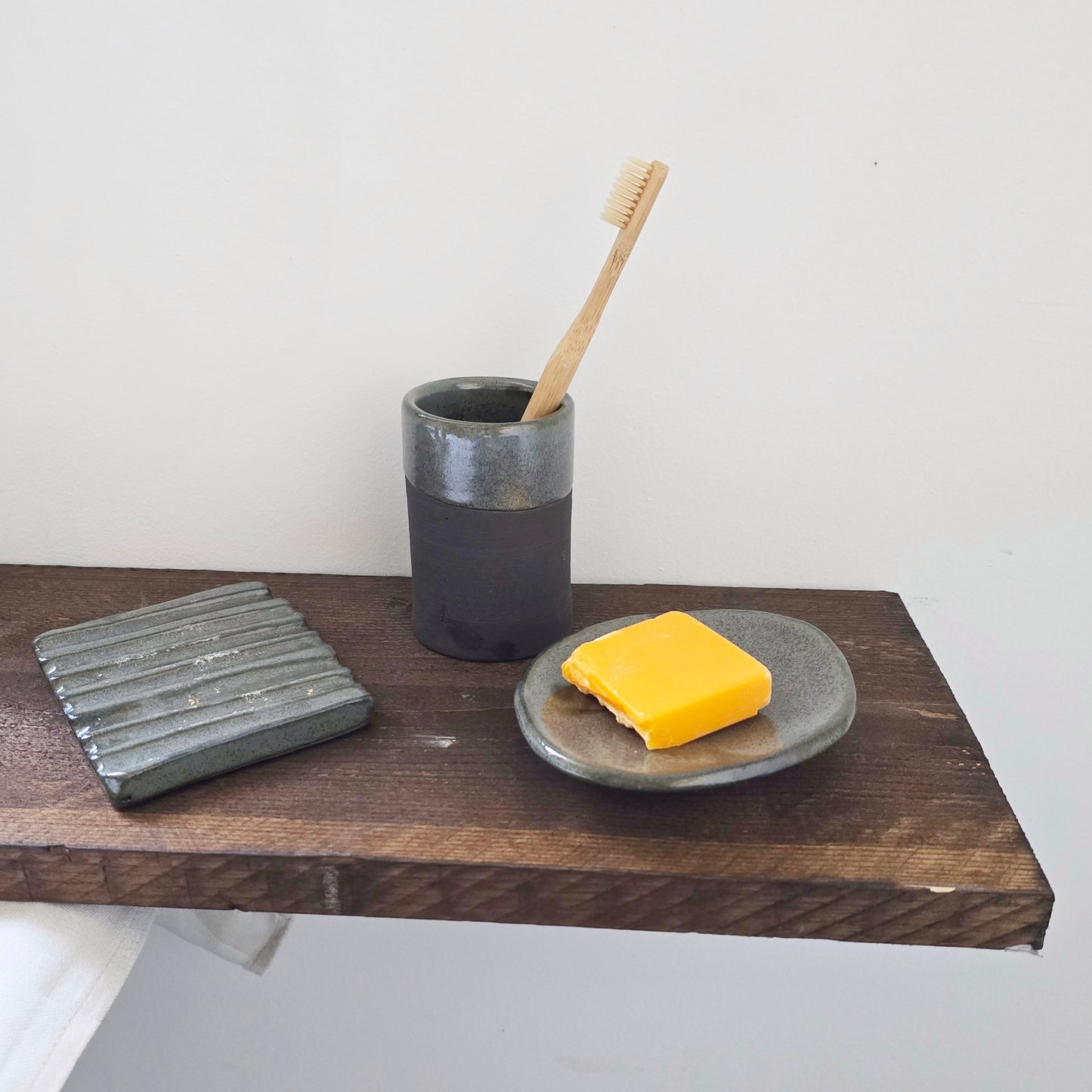 PORTA SAPONE di forma organica con piedini in gres nero di diversi colori e dimensioni